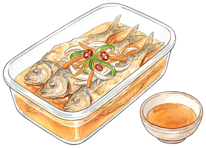 南蛮酢と野菜を入れた保存容器に、揚げた小アジを漬けているイラスト